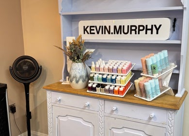 Product display at South Beach Salon, Helston, England, GB featuring vibrant hair colors and styling products.