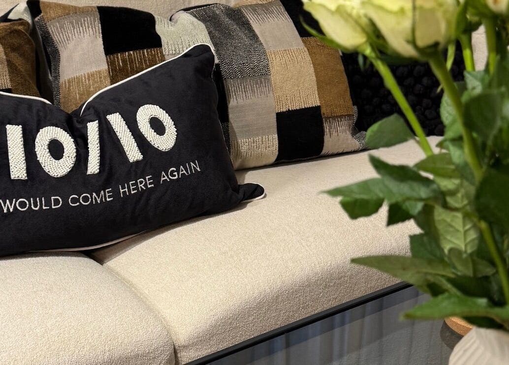 Stylish seating with a pillow saying '10/10' at Nova Wellness, Helston, GB.