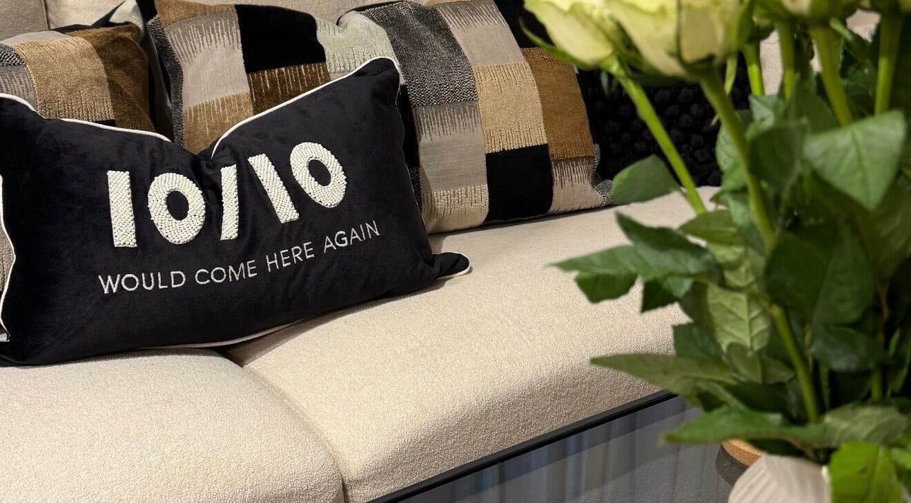 Stylish seating with a pillow saying '10/10' at Nova Wellness, Helston, GB.