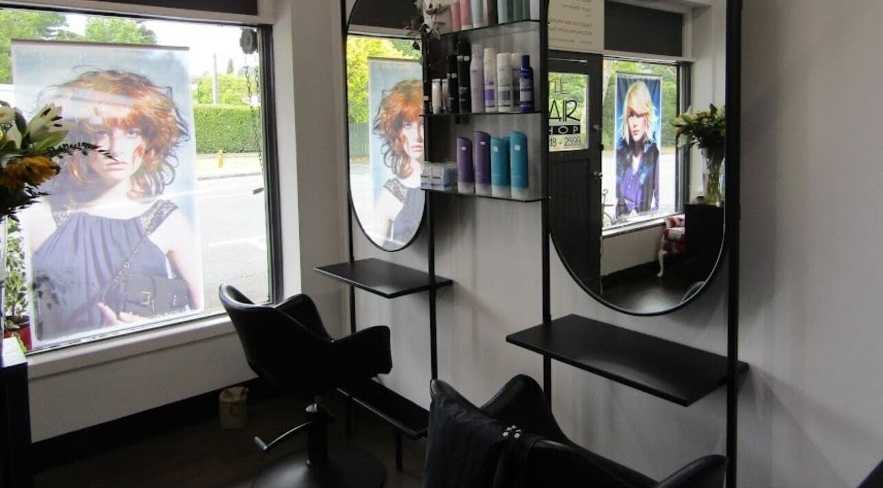 Modern hair salon interior at Hair By Sarah Cook in Auckland, Auckland, NZ featuring sleek mirrors and hair products.