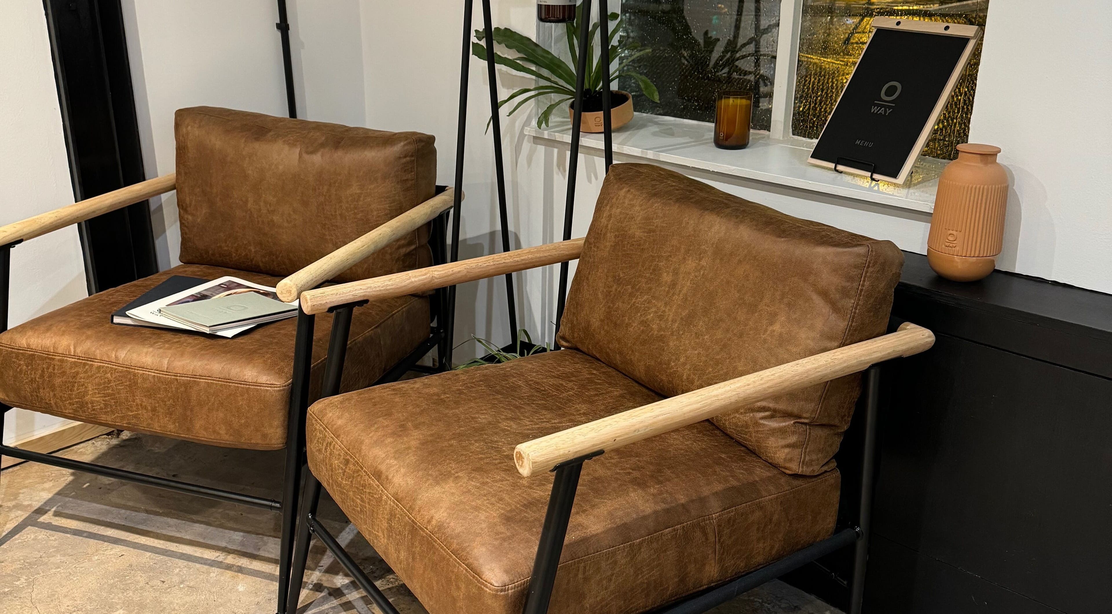 Stylish lounge area with leather chairs at Coco Salon, Wolverhampton, England, GB, offering comfort and elegance.