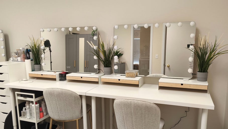 Elegant beauty station at Makeup by Inna, Edmonton, Alberta, CA, featuring mirrors and lush greenery.