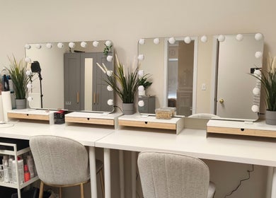 Elegant beauty station at Makeup by Inna, Edmonton, Alberta, CA, featuring mirrors and lush greenery.