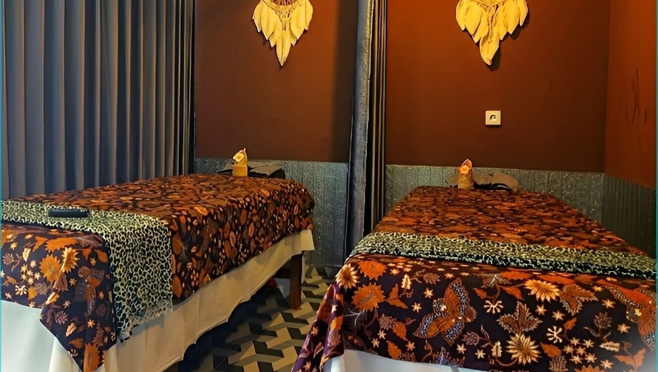 Two massage tables with floral covers at Chandra In Spa Massage And Reflexology, Bali, Bali, ID.