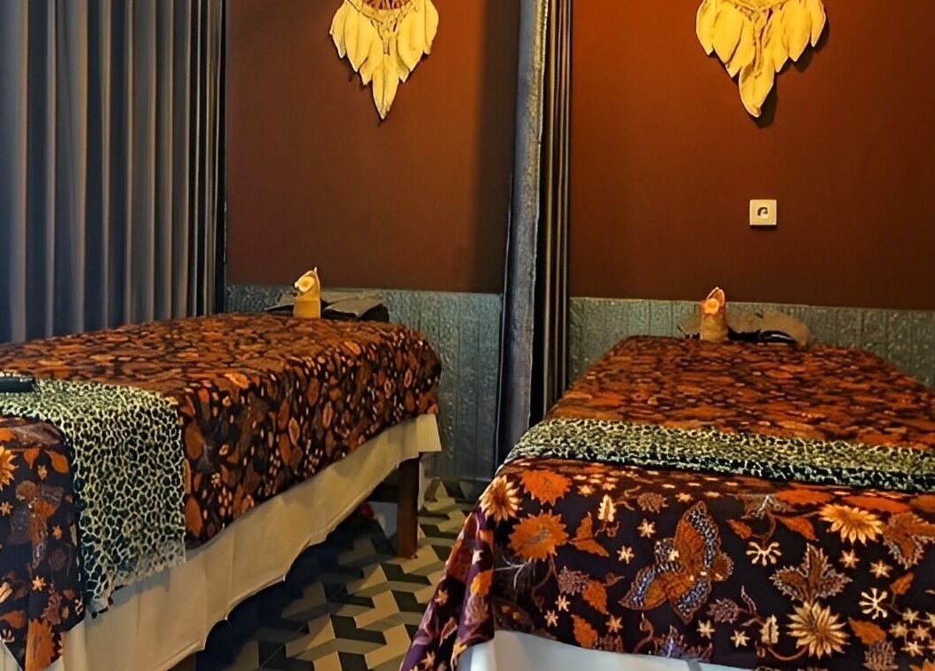 Two massage tables with floral covers at Chandra In Spa Massage And Reflexology, Bali, Bali, ID.