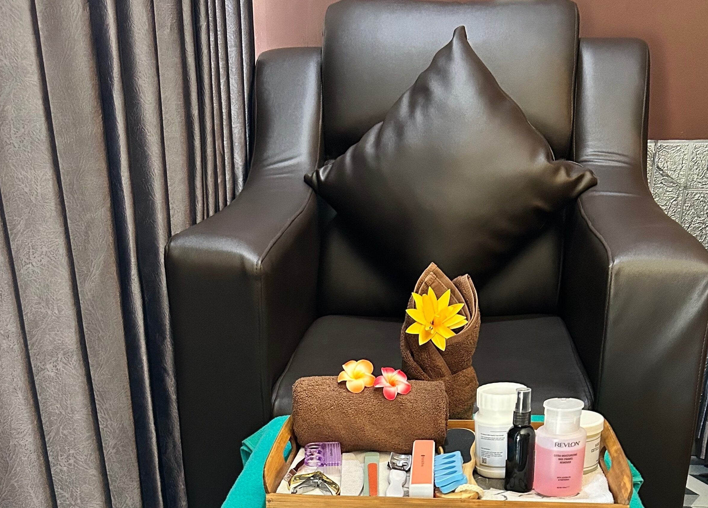 Comfortable spa chair at Chandra In Spa Massage And Reflexology, Bali, Bali, ID with beauty essentials.