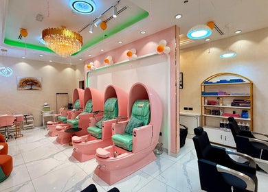 Luxurious nail spa area at Artika Beauty Lounge, Dubai, Dubai, AE with pink chairs and serene decor.