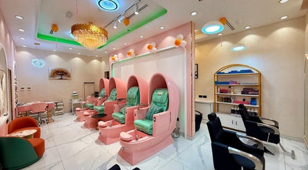 Luxurious nail spa area at Artika Beauty Lounge, Dubai, Dubai, AE with pink chairs and serene decor.