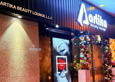 Artika Beauty Lounge entrance adorned with vibrant flowers in Dubai, Dubai, AE.