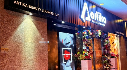 Artika Beauty Lounge entrance adorned with vibrant flowers in Dubai, Dubai, AE.