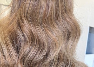 Soft blonde waves styled at Luxe Hair Studio, Edinburgh, Scotland, GB. Perfect for a fresh, chic look.