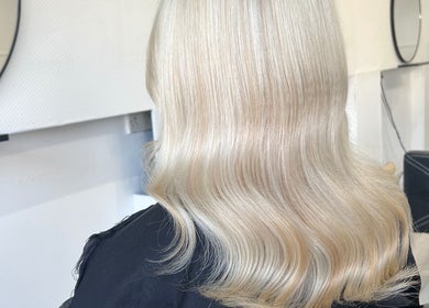 Sleek, styled blonde hair showcased at Luxe Hair Studio, Edinburgh, Scotland, GB.