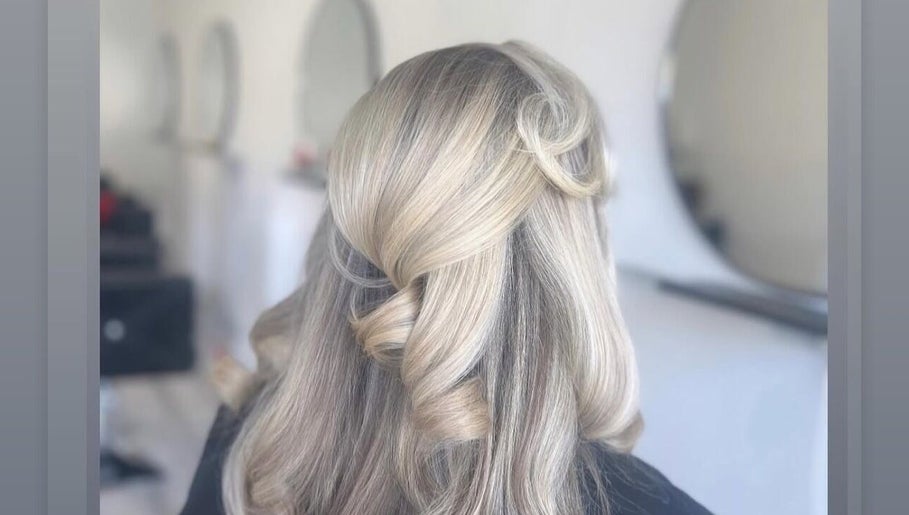 Styled blonde hair at Luxe Hair Studio, Edinburgh, Scotland, GB showcasing sophisticated curls and shine.