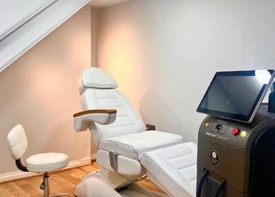 Modern treatment room at The Ati Clinic, London, England, GB, featuring advanced equipment and white recliner.