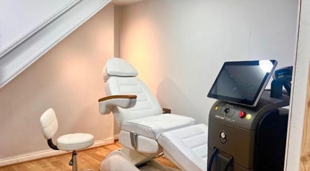 Modern treatment room at The Ati Clinic, London, England, GB, featuring advanced equipment and white recliner.