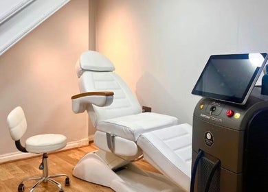 Treatment room with white chair and laser machine at The Ati Clinic, London, England, GB.