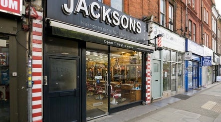 Street view of The Ati Clinic in London, England, GB, showcasing neighboring shops and vibrant urban atmosphere.