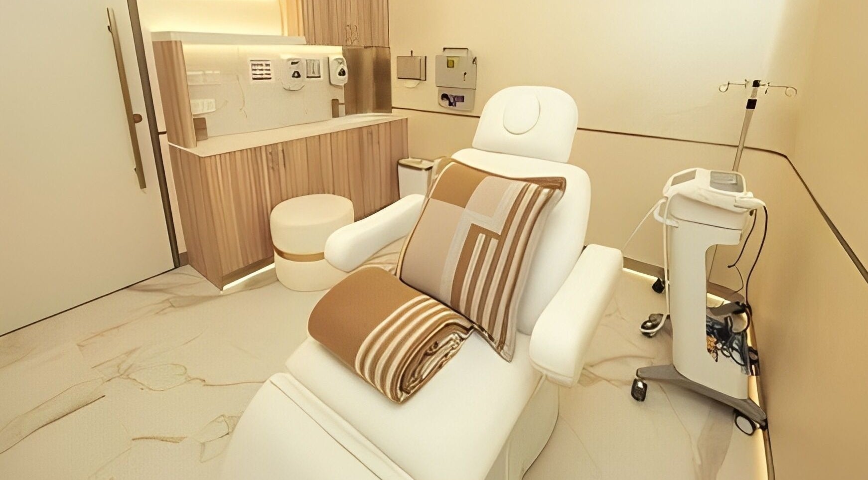 Tranquil treatment room at Reborn Clinic, Dubai, Dubai, AE, featuring plush seating and modern equipment.