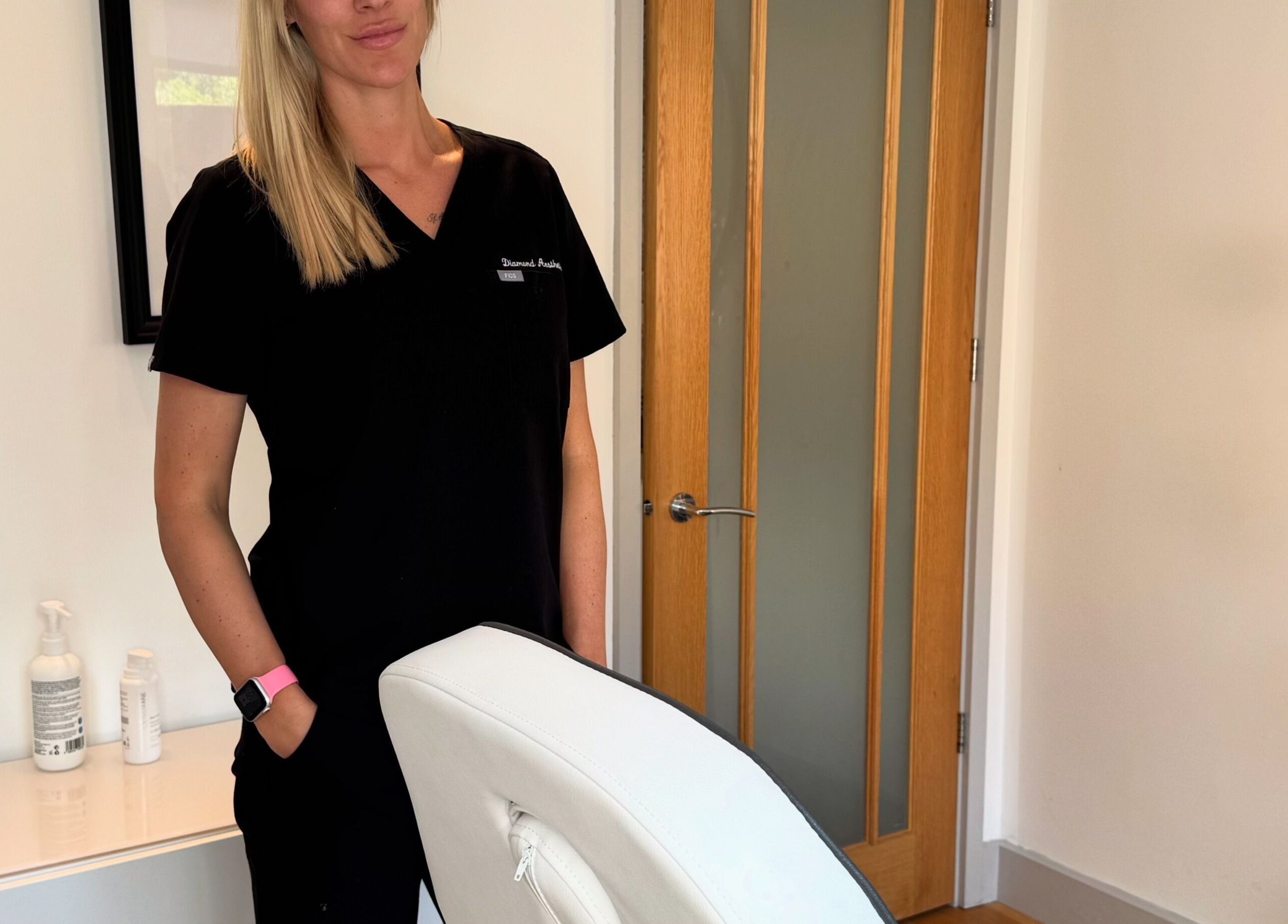 Professional at Diamond Aesthetics in a serene treatment room, Reading, England, GB.