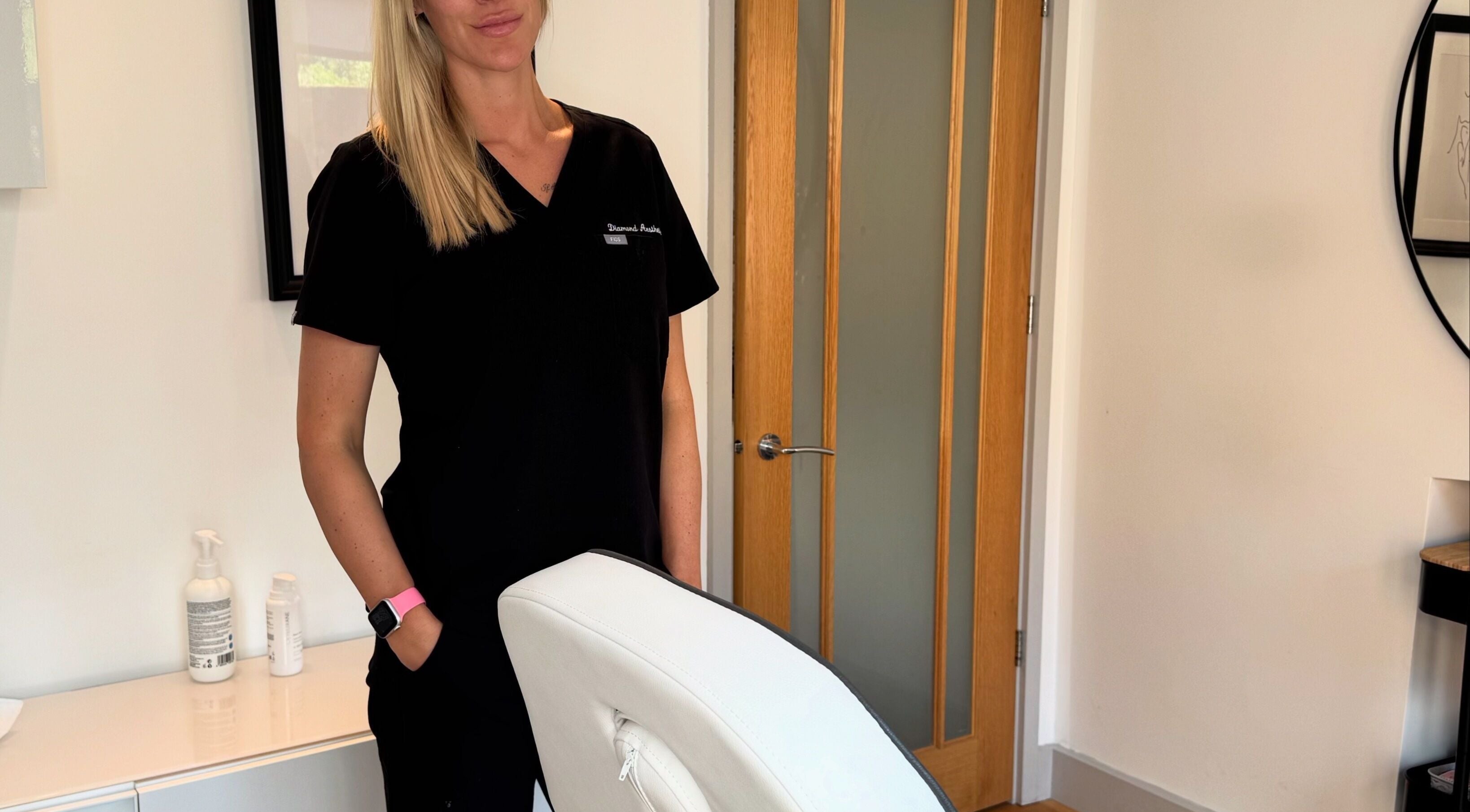 Professional at Diamond Aesthetics in a serene treatment room, Reading, England, GB.
