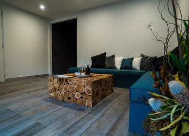 Modern waiting area at Innerverse Wellness Centre - Southbank, Melbourne, AU with wooden table and cozy seating.
