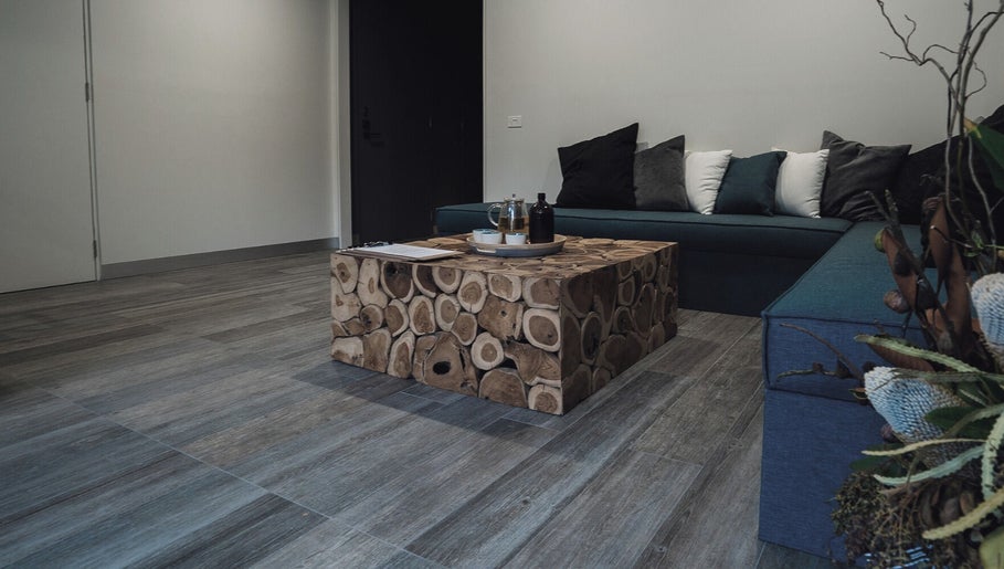 Cozy seating area at Innerverse Wellness Centre - Southbank, Melbourne, AU with wooden table.