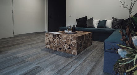 Cozy seating area at Innerverse Wellness Centre - Southbank, Melbourne, AU with wooden table.