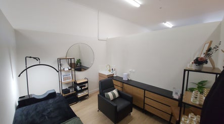 Serene spa room at BNV'D Beauty, Melbourne, Victoria, AU with elegant decor and comfortable seating.