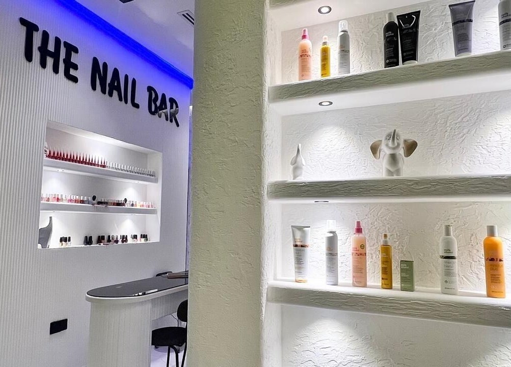 The Nail Bar at Capri Beauty Center in Sharjah, AE, showcasing a stylish product display wall.