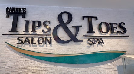 Candy’s Tips & Toes Salon & Spa logo on a textured wall in Ocho Rios, St. Ann Parish, JM.