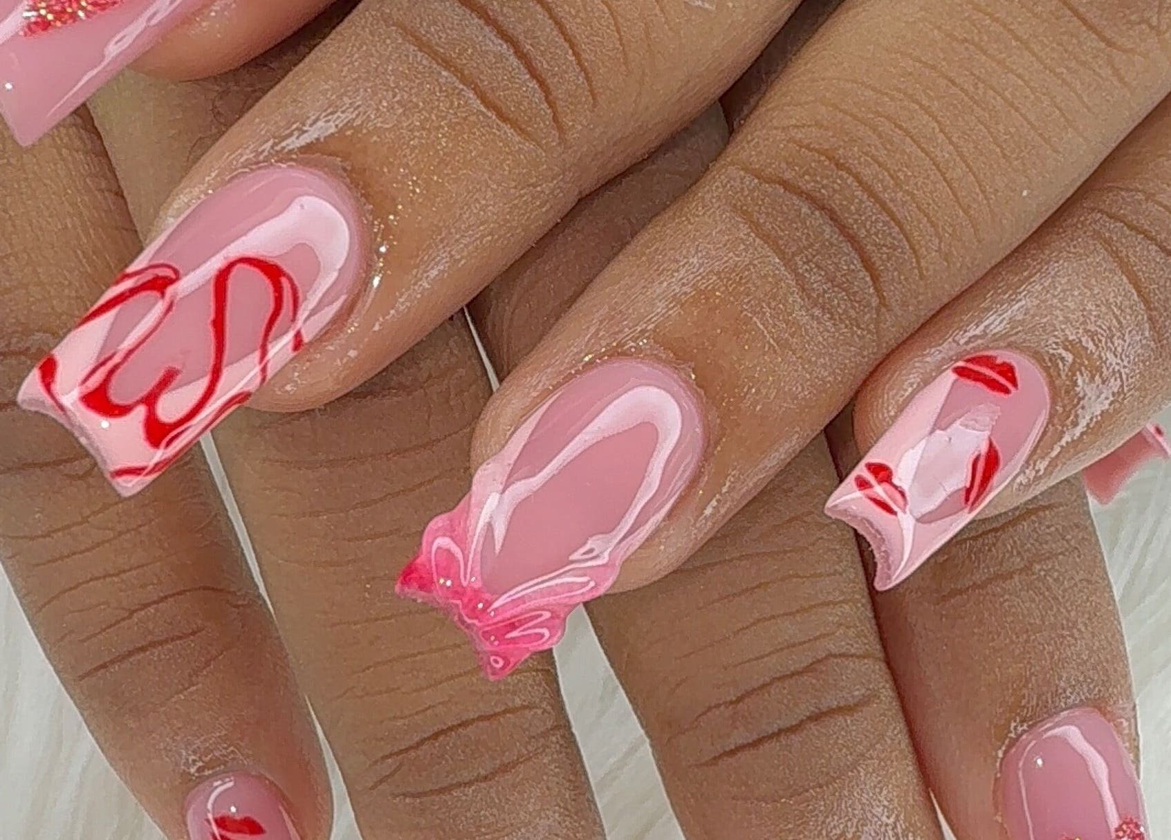 Red and pink nail art manicure at Candy’s Tips & Toes Salon & Spa in Ocho Rios, St. Ann Parish, JM.