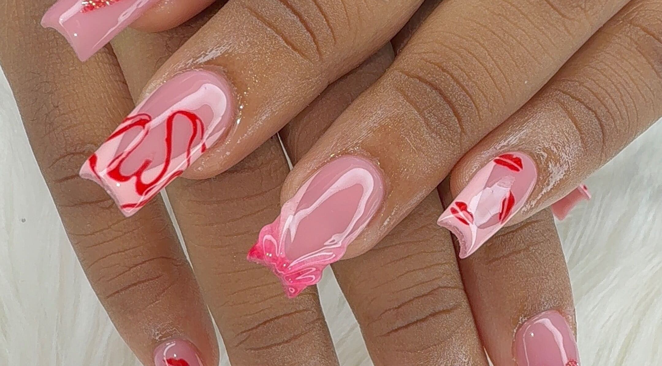Red and pink nail art manicure at Candy’s Tips & Toes Salon & Spa in Ocho Rios, St. Ann Parish, JM.