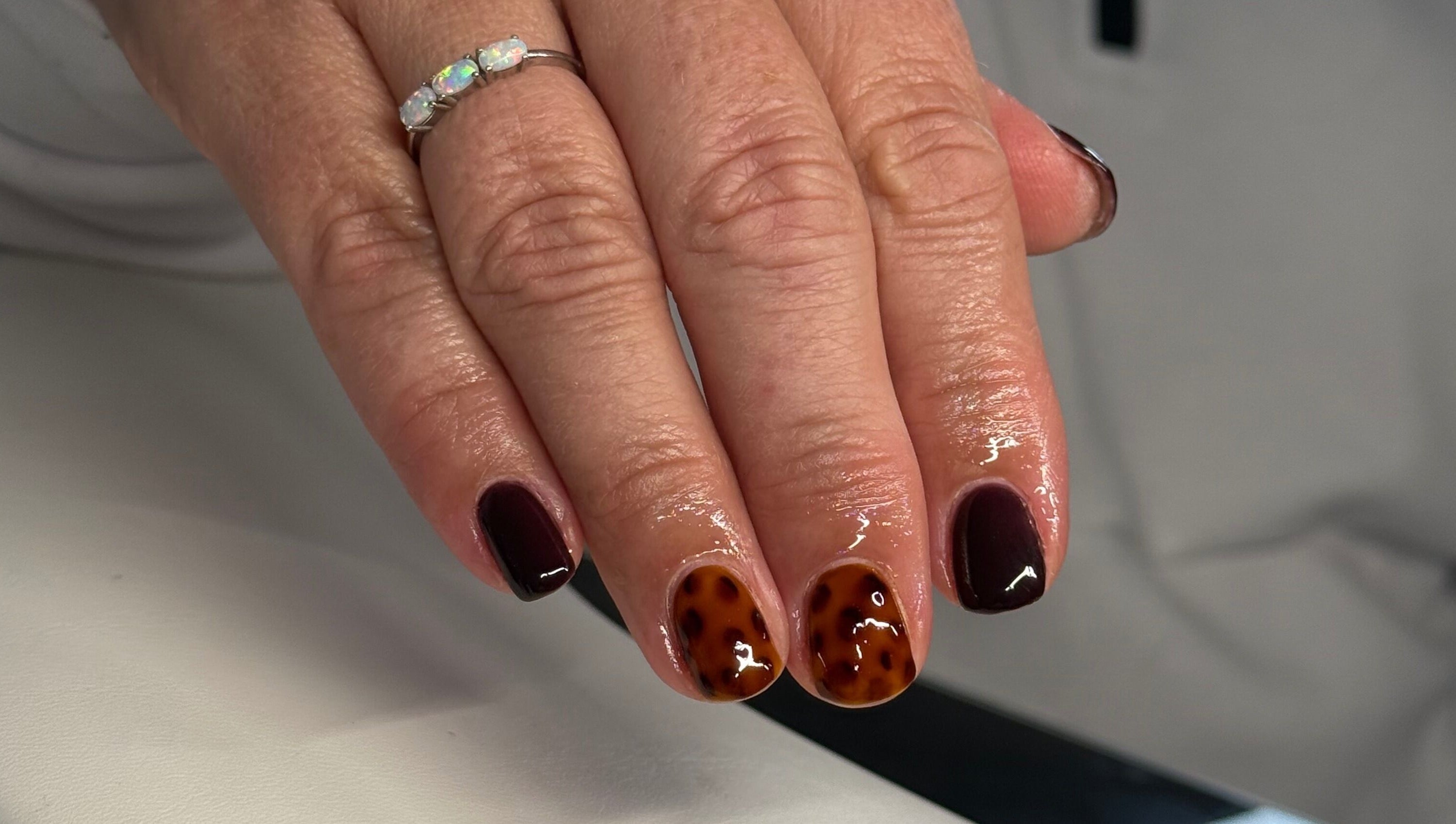 Elegant tortoise shell nail design at HJMNails, Haywards Heath, England, GB. Perfect manicure for style enthusiasts.