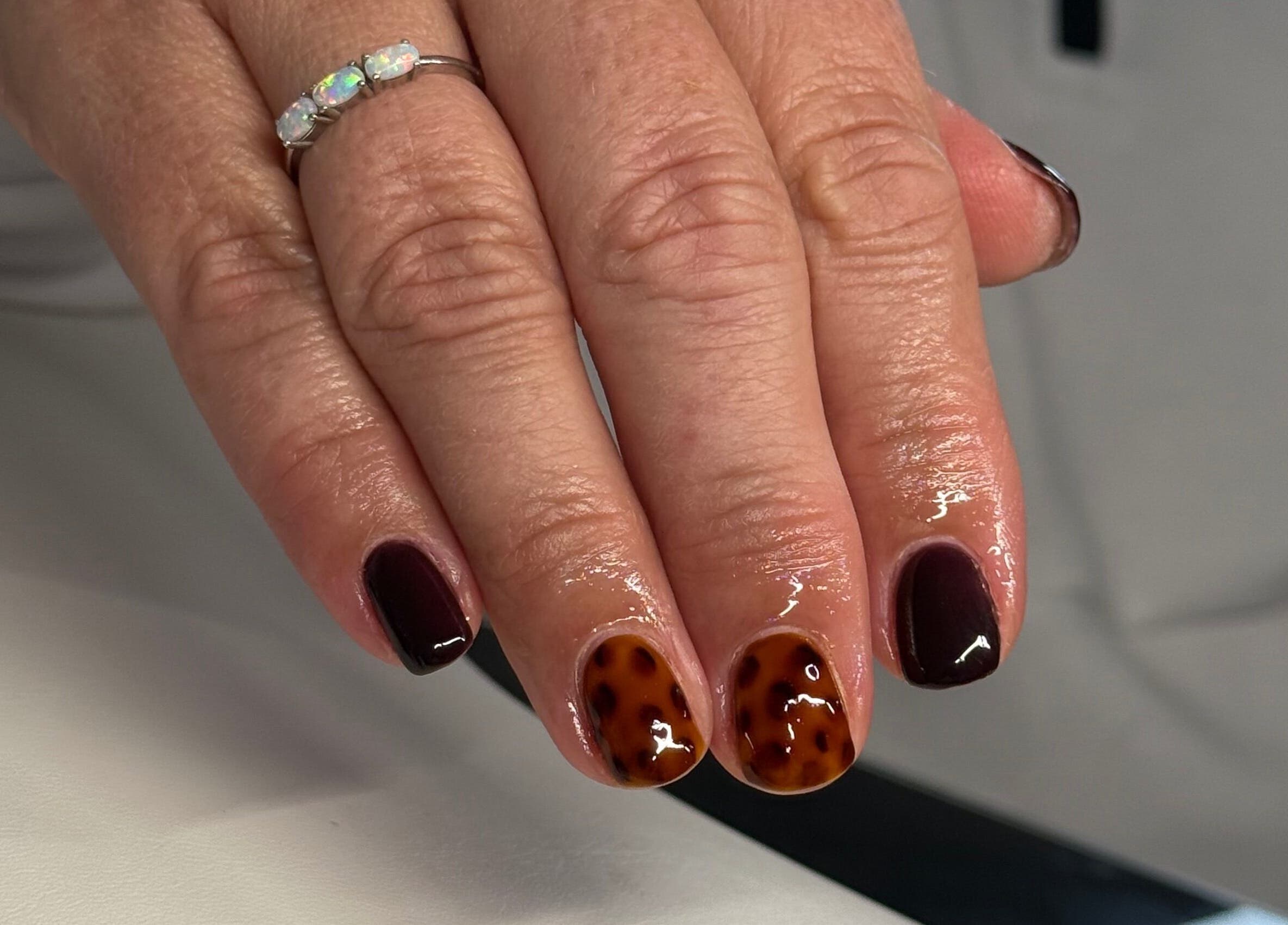 Elegant tortoise shell nail design at HJMNails, Haywards Heath, England, GB. Perfect manicure for style enthusiasts.