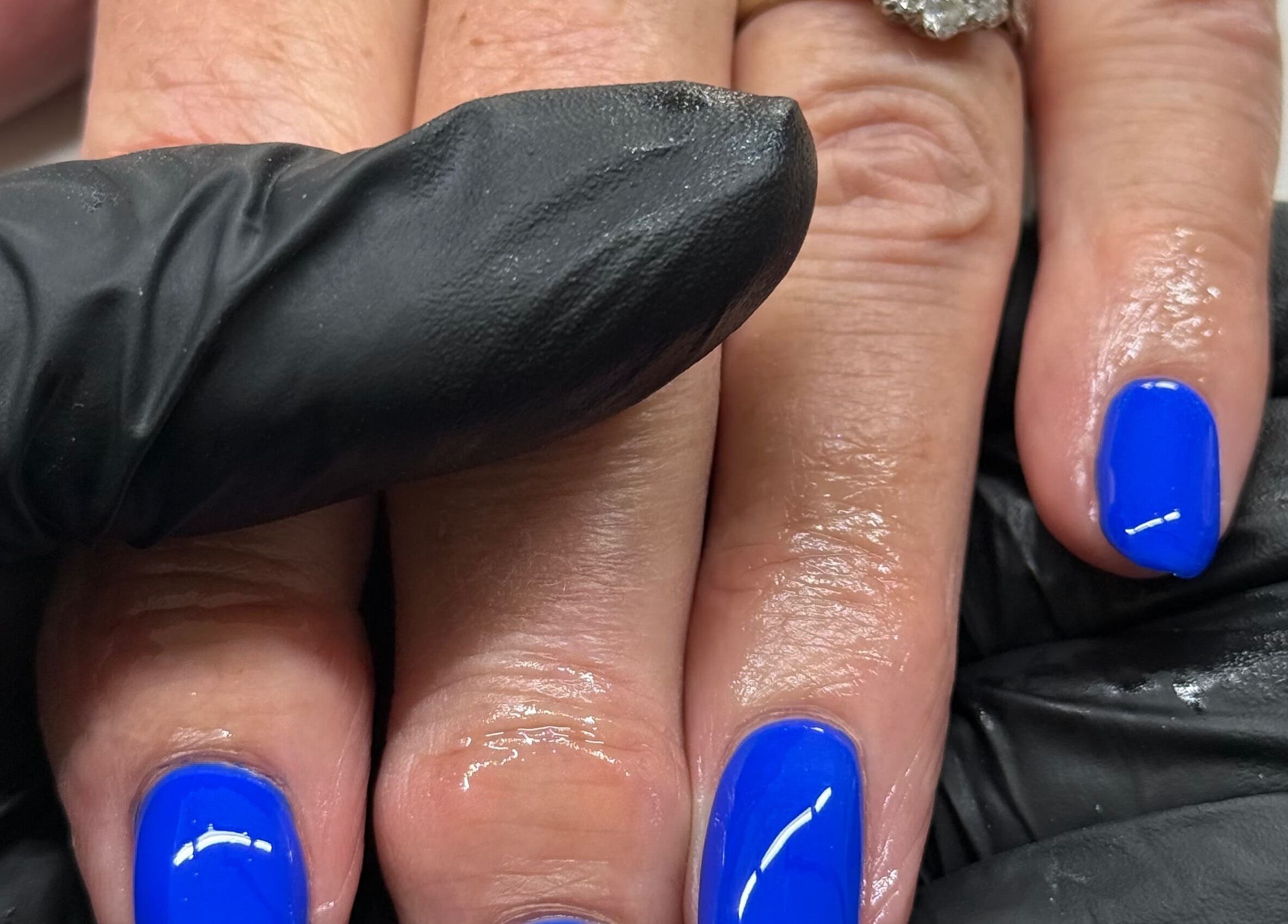 Bright blue manicure at HJMNails in Haywards Heath, England, GB, showcasing expert nail care.