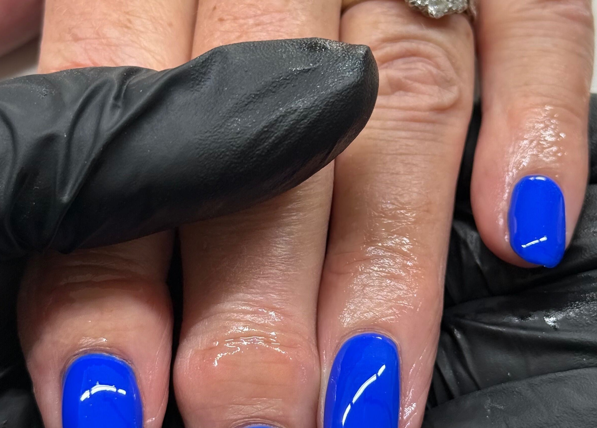 Bright blue manicure at HJMNails in Haywards Heath, England, GB, showcasing expert nail care.