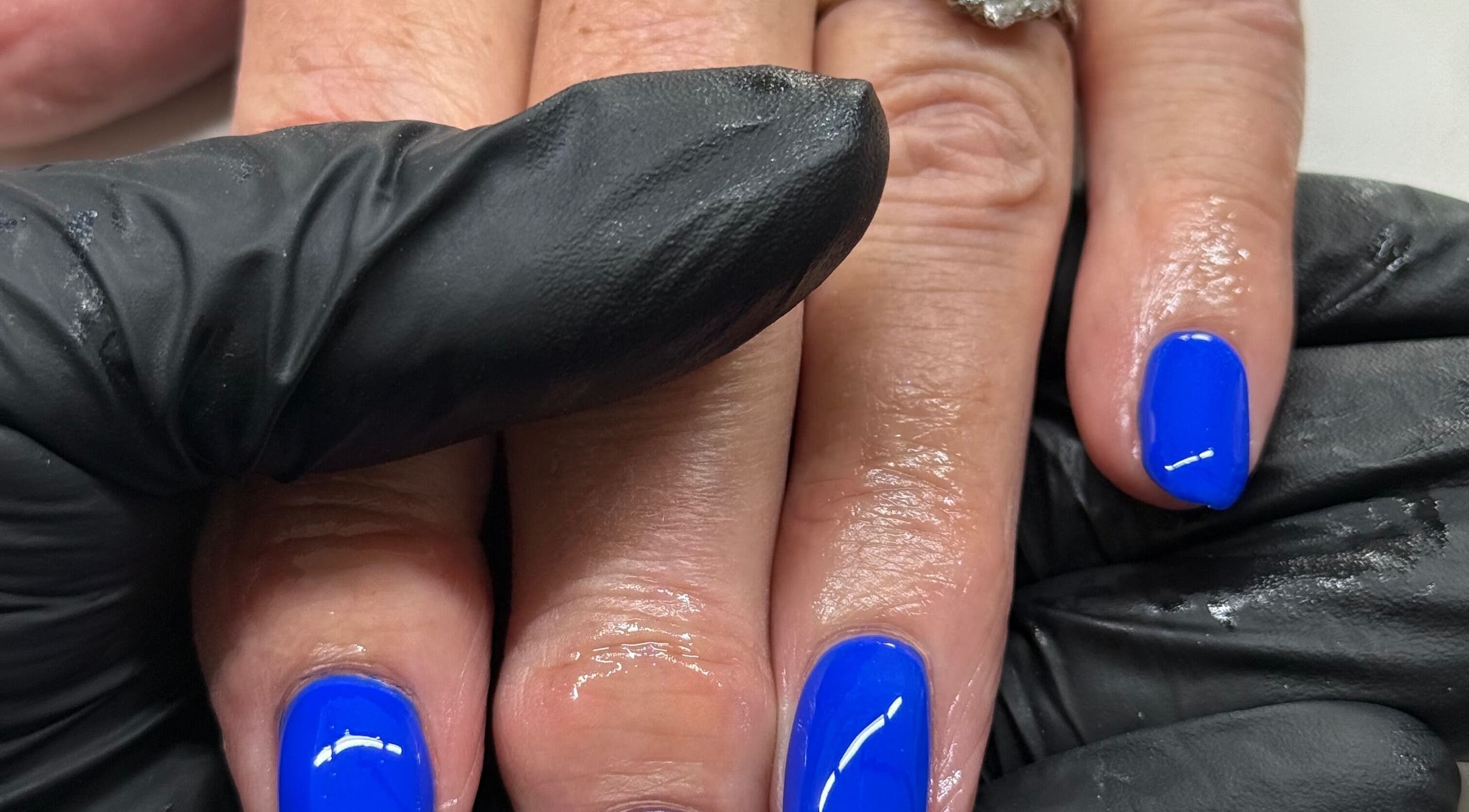 Bright blue manicure at HJMNails in Haywards Heath, England, GB, showcasing expert nail care.