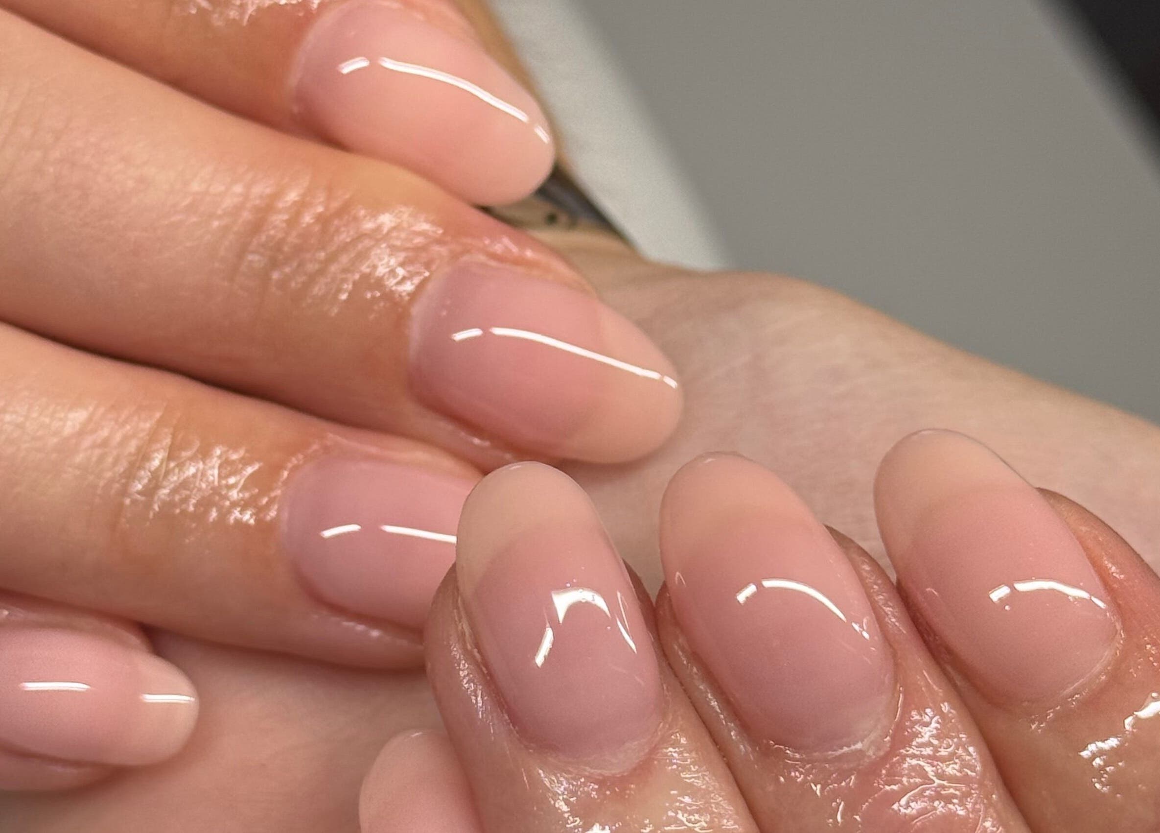 Beautifully manicured nails at HJMNails, Haywards Heath, England, GB showcasing a glossy finish.