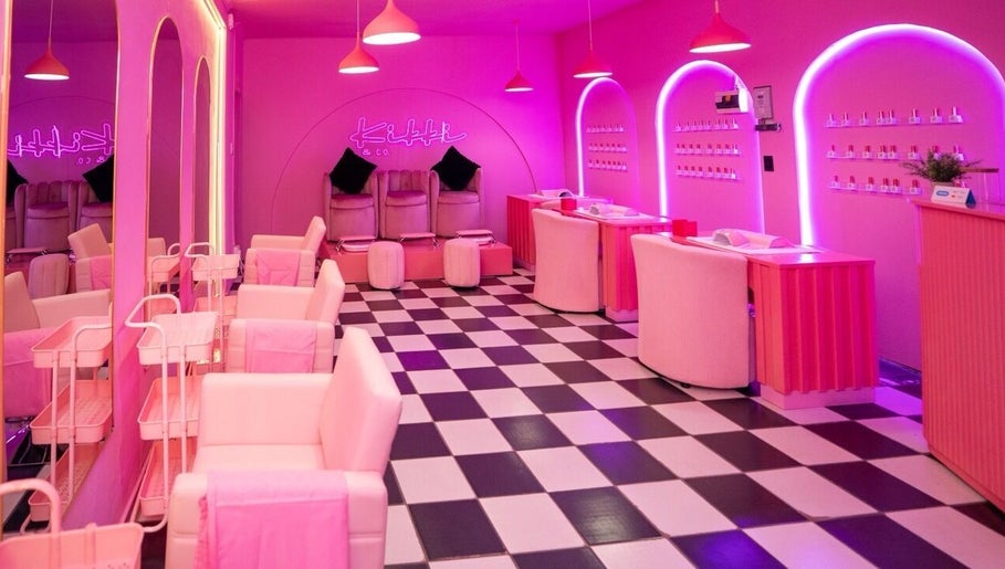 Chic interior of Kikki & Co Beauty Bar in Cape Town, Western Cape, ZA, featuring pink decor and stylish seating.