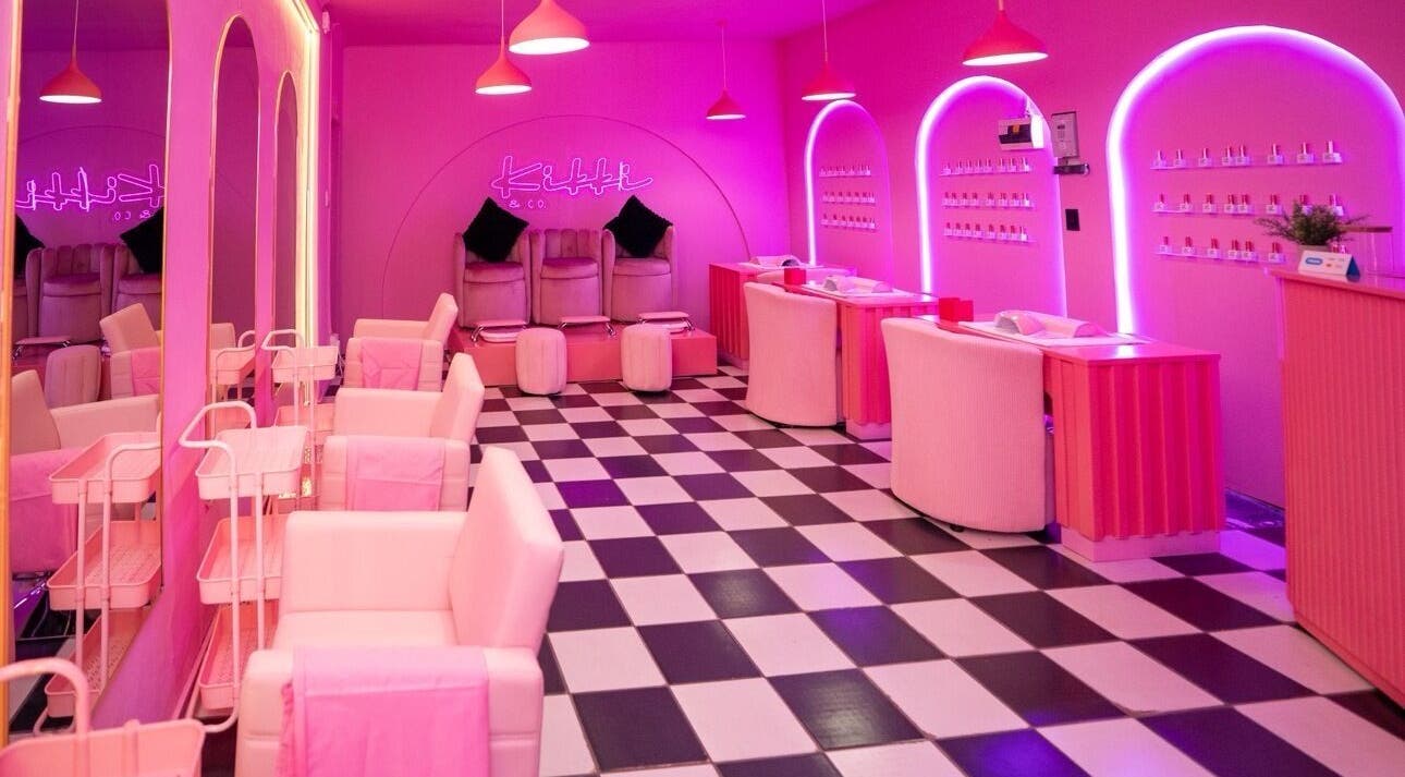 Chic interior of Kikki & Co Beauty Bar in Cape Town, Western Cape, ZA, featuring pink decor and stylish seating.