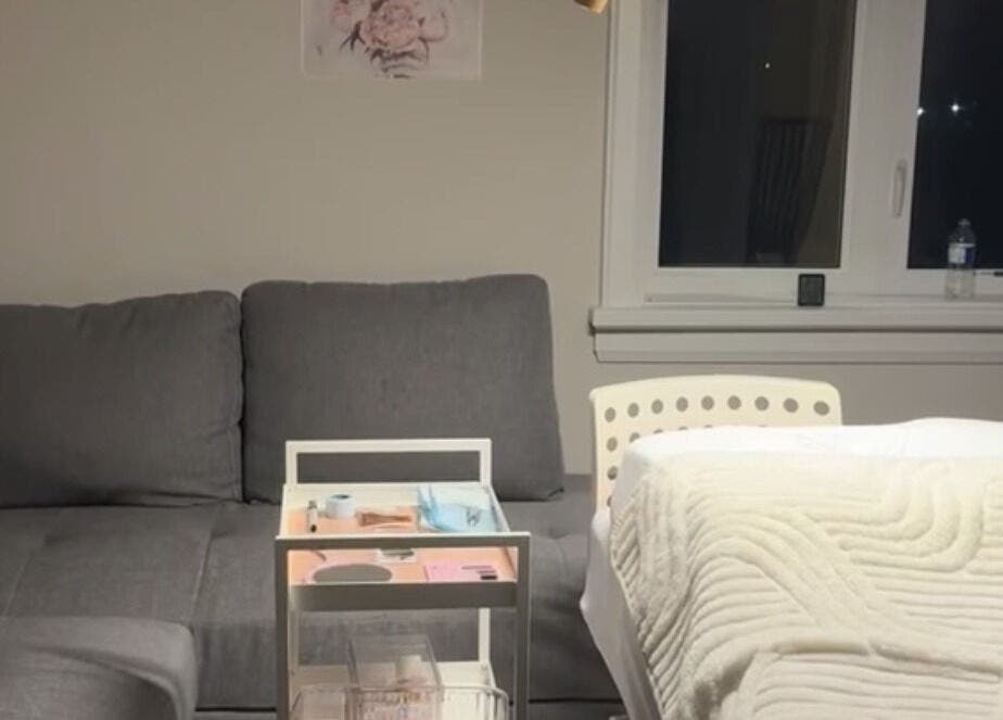 Luxurious treatment area at The Beauty Club AM (Vaughan), Vaughan, Ontario, CA, featuring a plush couch and massage bed.