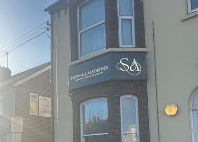 Front view of Sabrina's Aesthetic Training Academy in Luton, England, featuring the academy's signage.