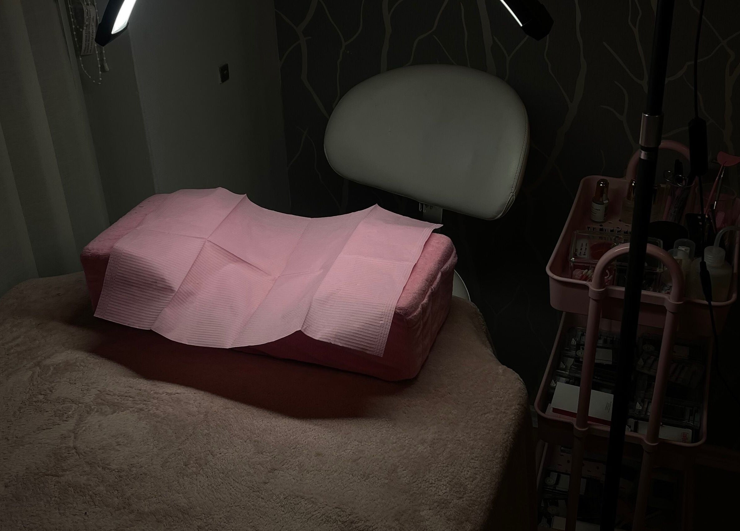 Cozy treatment room at Teeluxe Beauty, Potters Bar, England, GB, featuring a padded table and soft lighting.