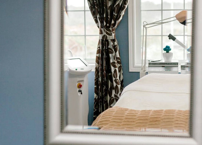 Cozy treatment room at Rapis Secret, WATERDOWN, Ontario, CA, with a window view and modern beauty equipment.