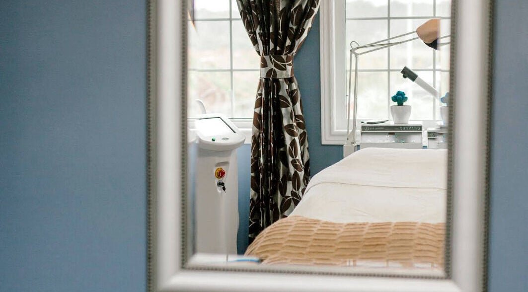 Cozy treatment room at Rapis Secret, WATERDOWN, Ontario, CA, with a window view and modern beauty equipment.