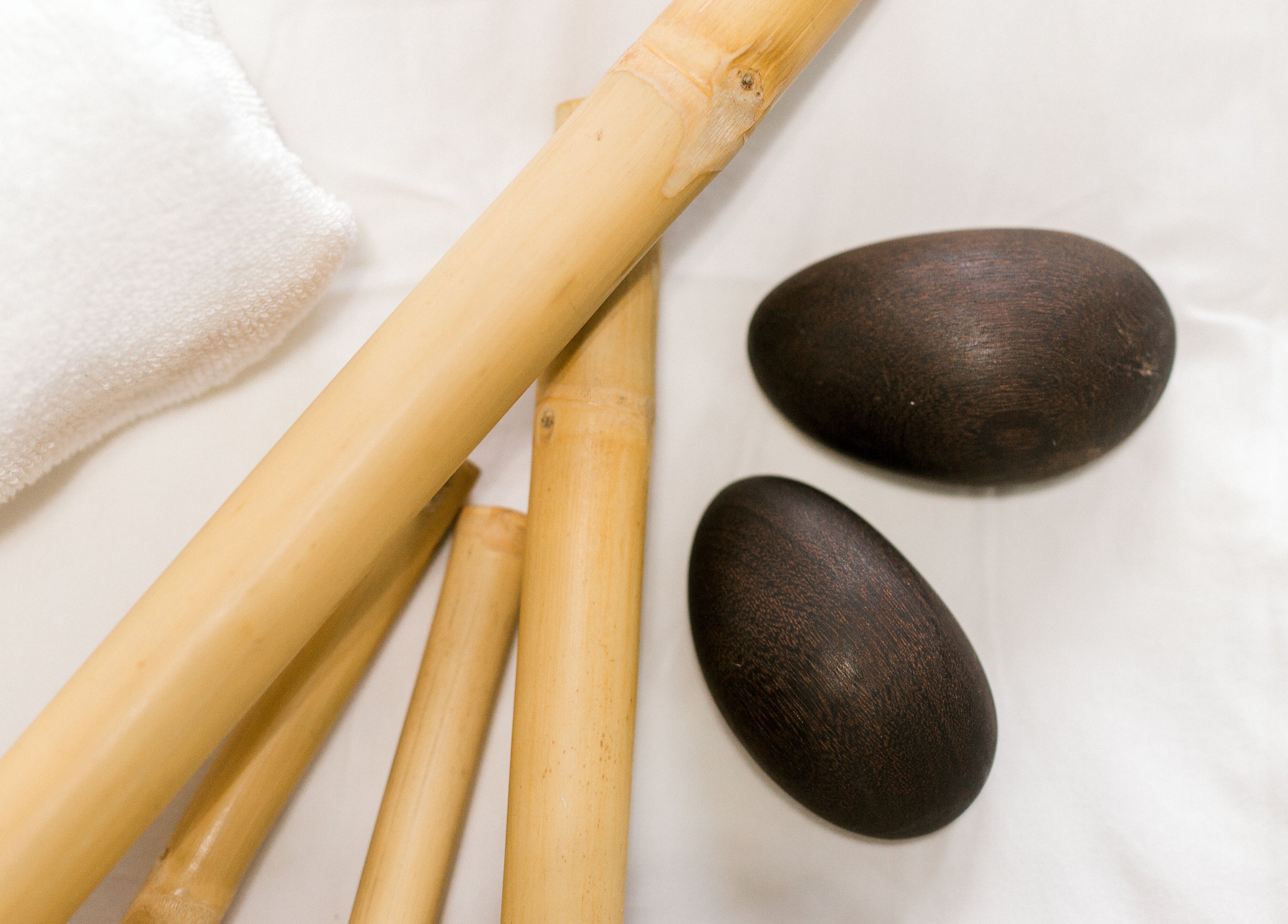 Bamboo sticks and stones on a towel at Rapis Secret, WATERDOWN, Ontario, CA.