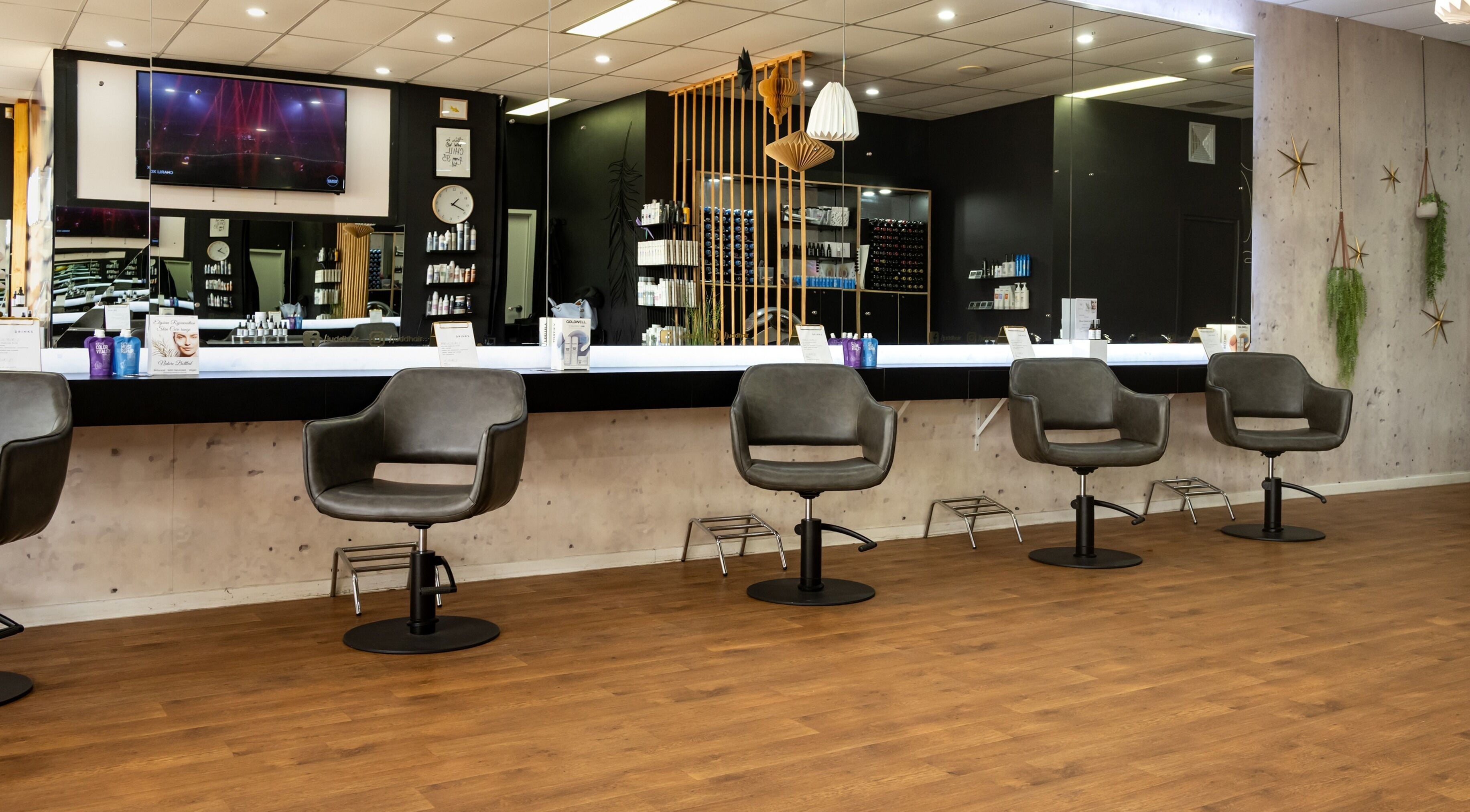 Modern salon interior at Judd Hair, Mountain Creek, Queensland, AU with sleek chairs and styling stations.