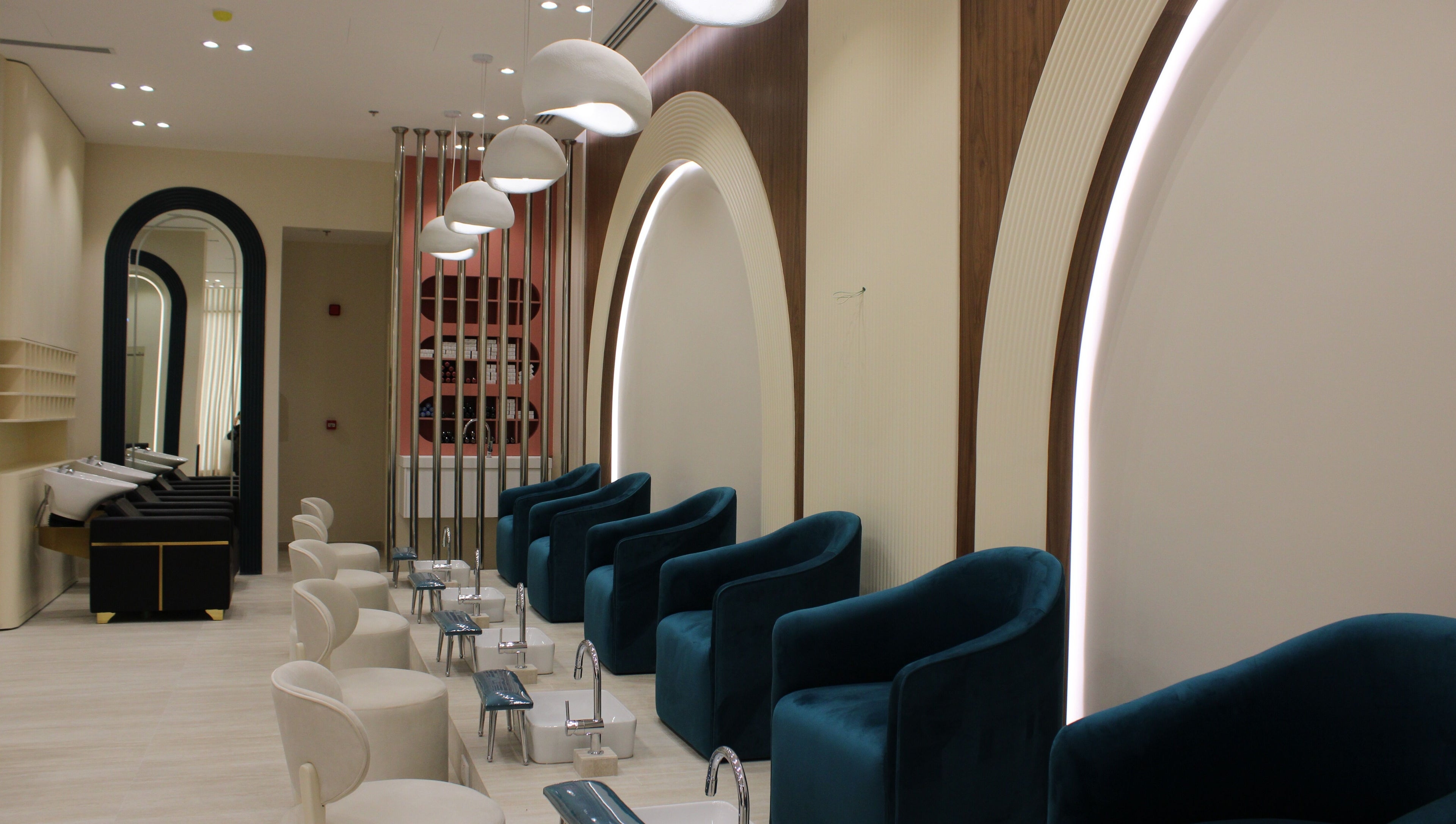 Elegant interior of Elysian Salon in Riyadh Province, featuring plush chairs and pedicure stations.