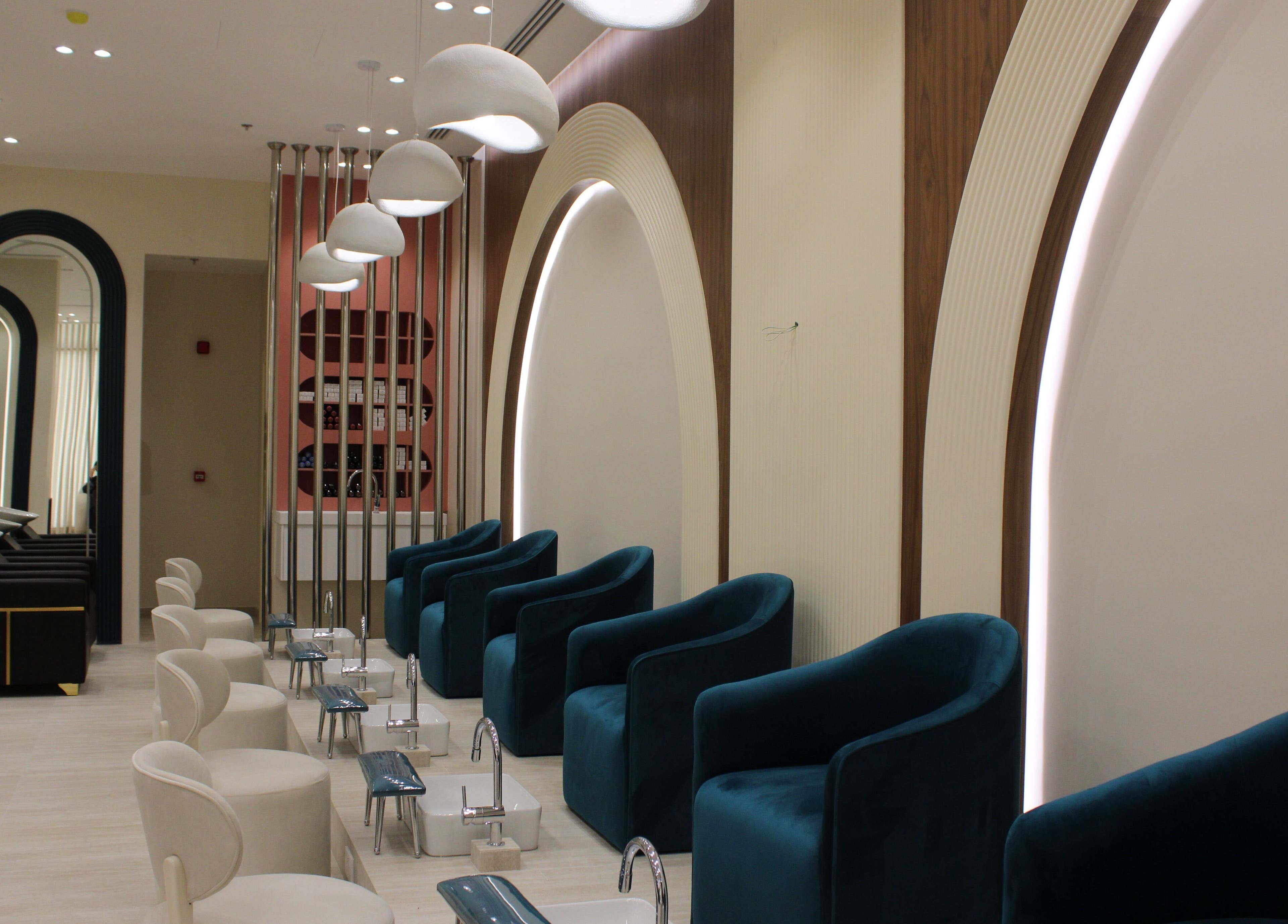 Elegant interior of Elysian Salon in Riyadh Province, featuring plush chairs and pedicure stations.