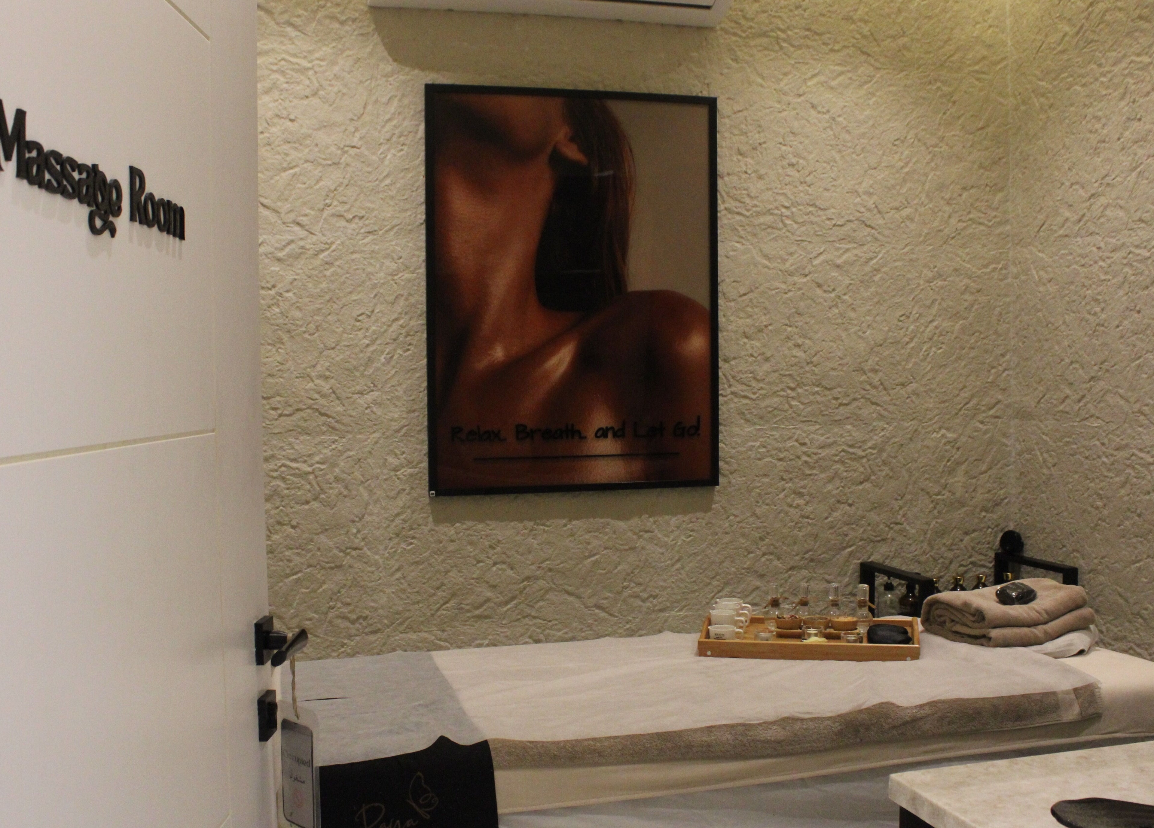 Relaxing massage room at Raya Spa in Riyadh, Riyadh Province, SA featuring a cozy treatment bed.